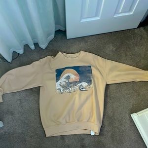 Handmade, Orange Sweatshirt with ocean sunset background.